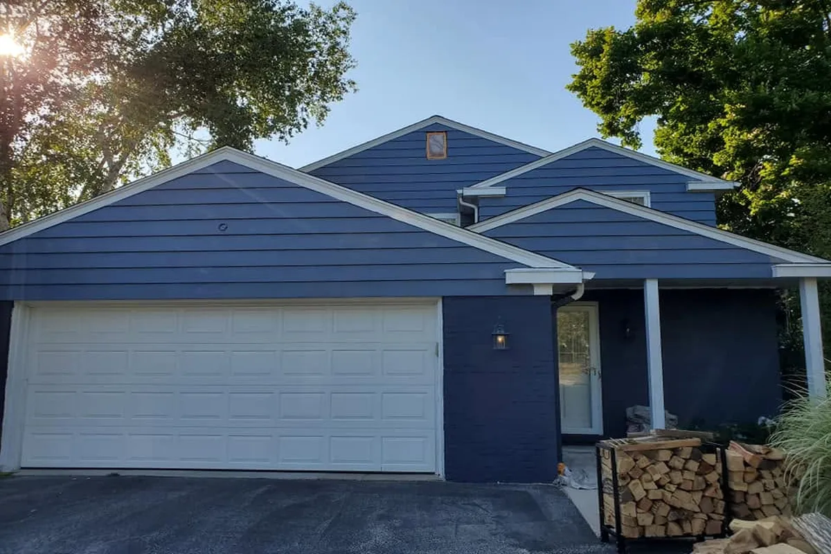 House with garage infront freshly painted blue