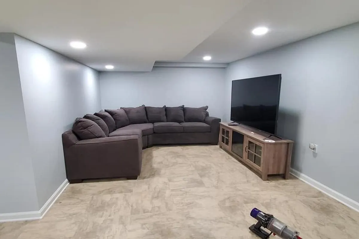 Finished basement with light gray painted walls